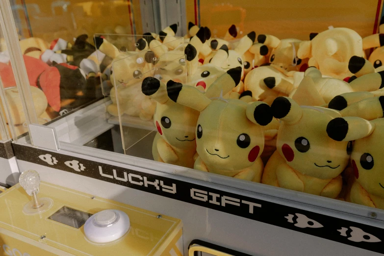 several yellow stuffed pikachu dolls are lined up in a store