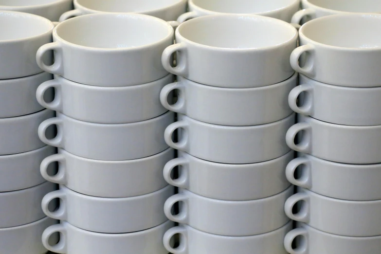 a large group of white cups with handles