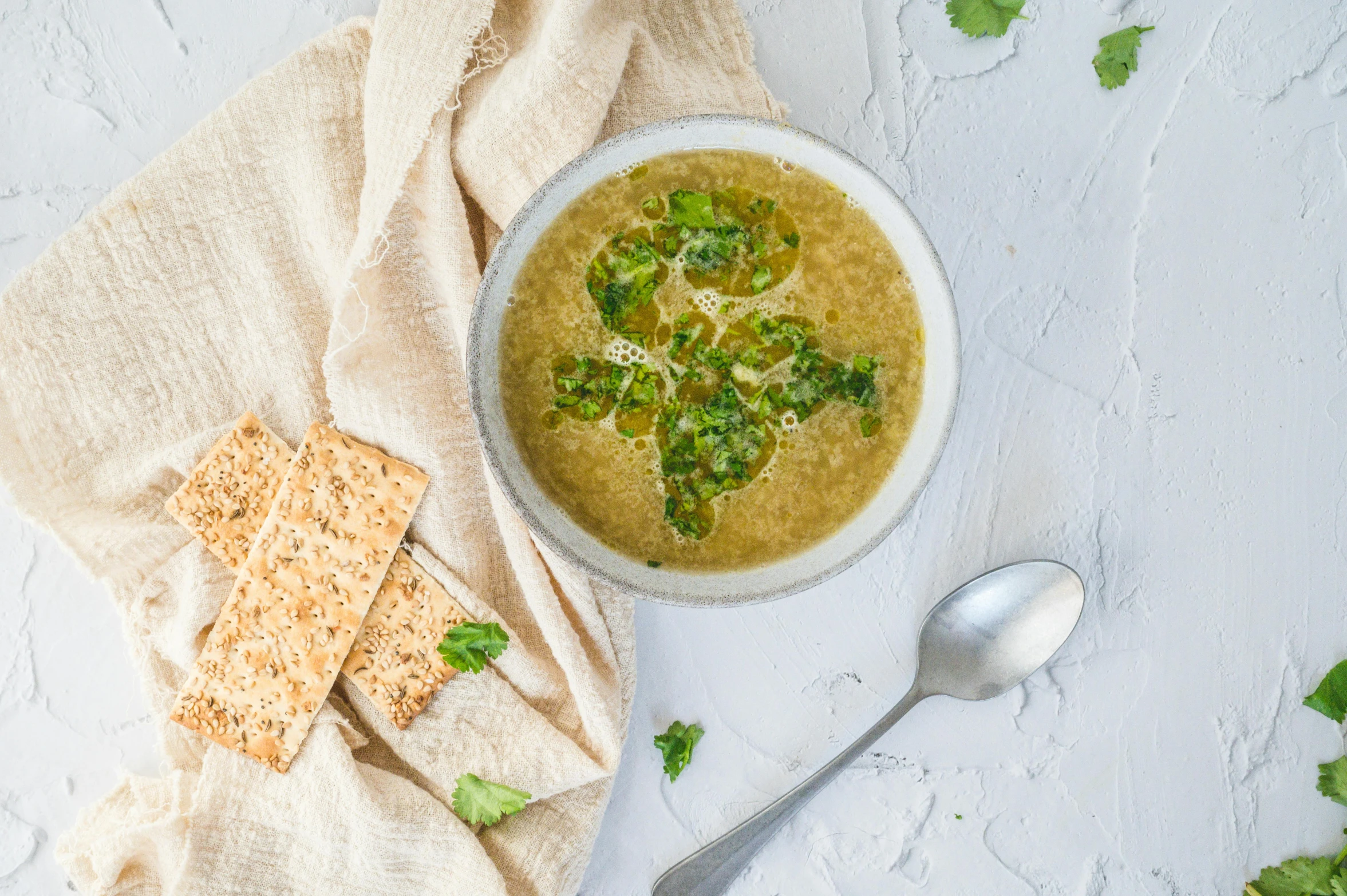 a bowl of broccoli soup with ers, parsley and parsley on the side