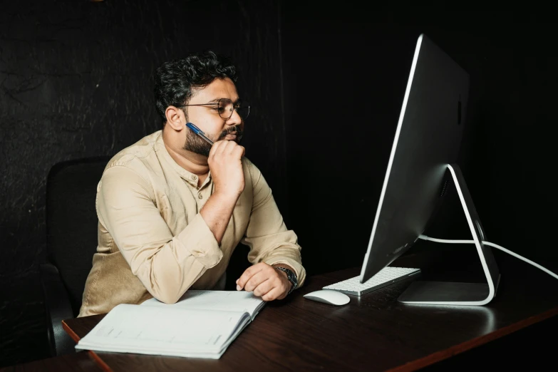 a man who is sitting in front of a computer