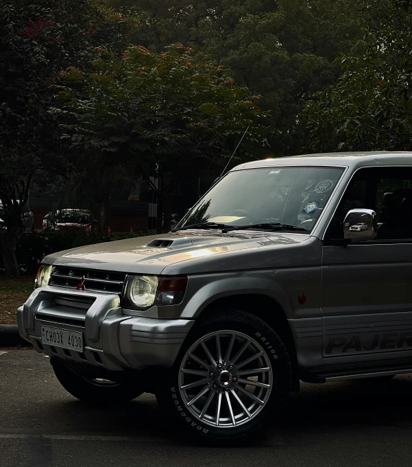 a grey land rover is parked on the street