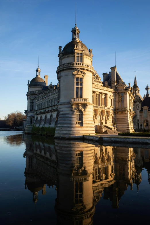 a large white building sitting next to a body of water