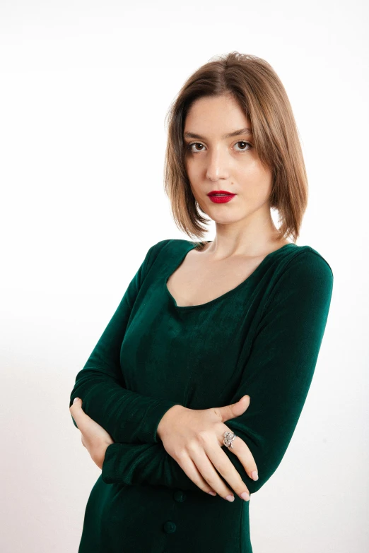 woman in green sweater posing for a po