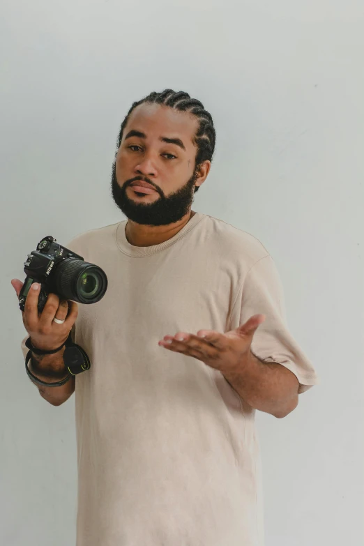 a man with a camera showing his hand gestures