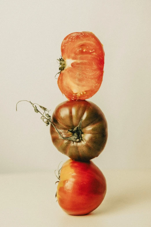 there are many tomatoes stacked on each other