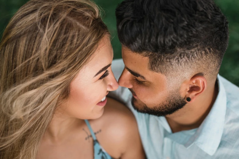 young couple with wedding ring, showing side to the camera