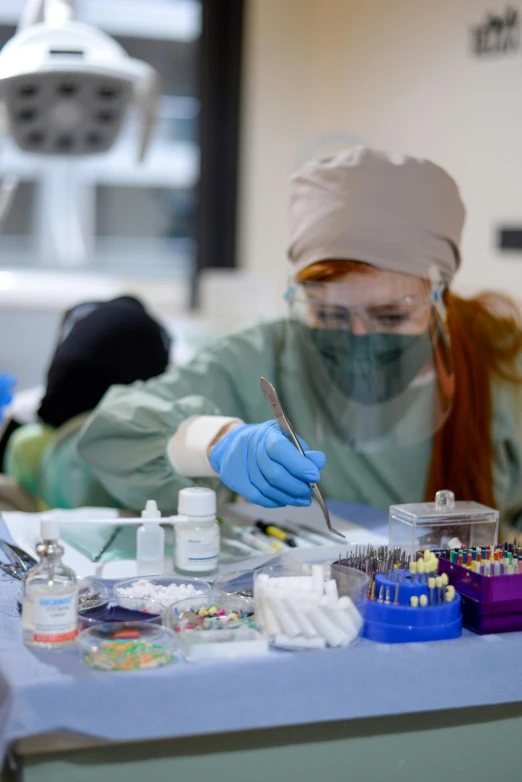 a surgeon is putting on gloves in a hospital