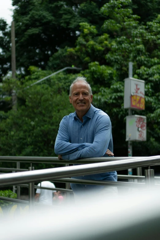 a man that is standing by a rail