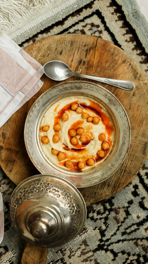 a metal bowl with beans in it on top of a table