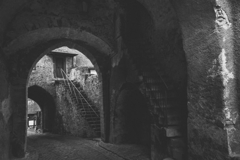 the stairs and arched ceilings in an old medieval looking town