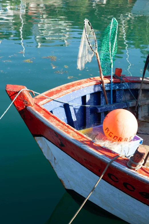 an orange and white boat docked at a dock