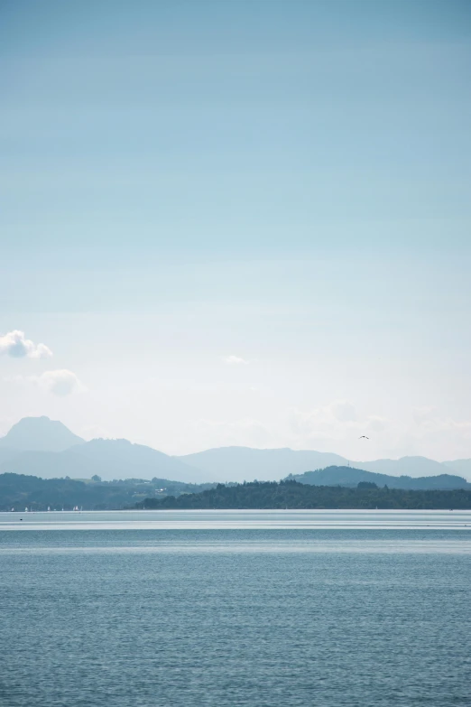 a long boat is floating on a large body of water