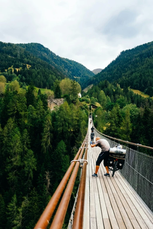 a long bridge with lots of people walking on it