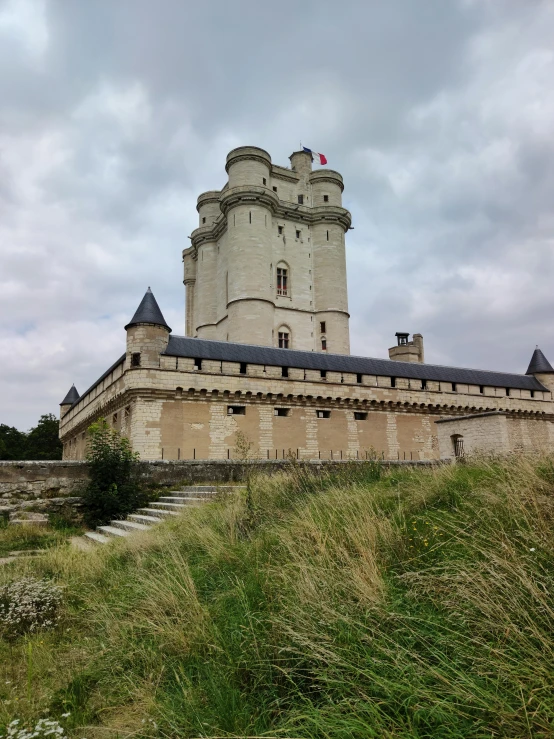 the old castle is perched high above the land