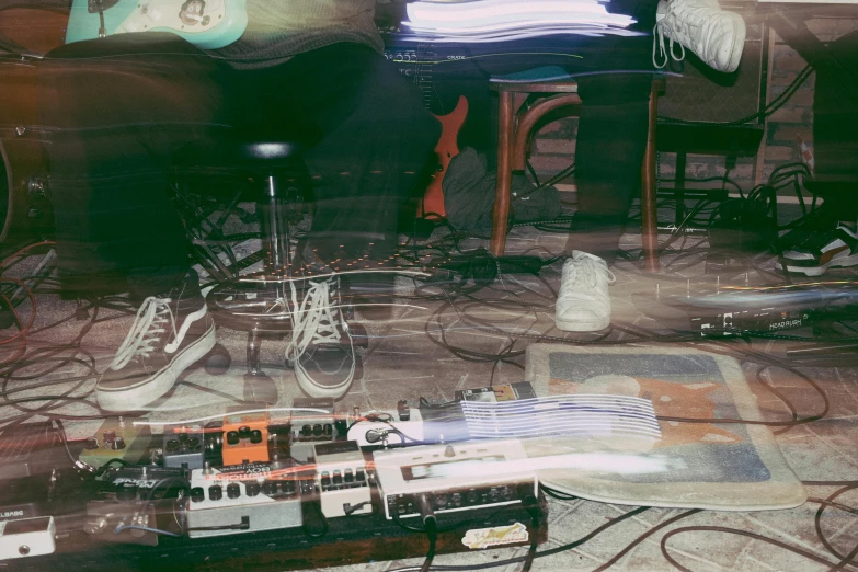 a living room area with a messy couch, chair and computer equipment