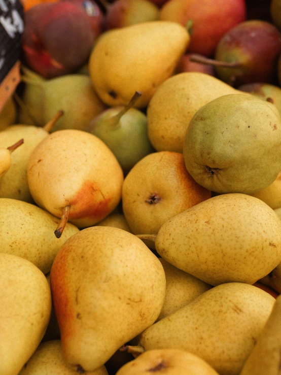 yellow pears and other fruit in a bowl