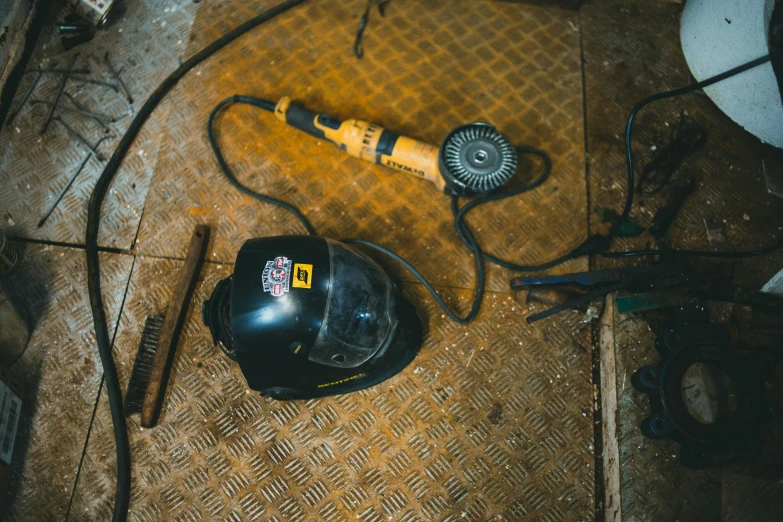 drill, hard hat, hairdryer and tools lay on the floor