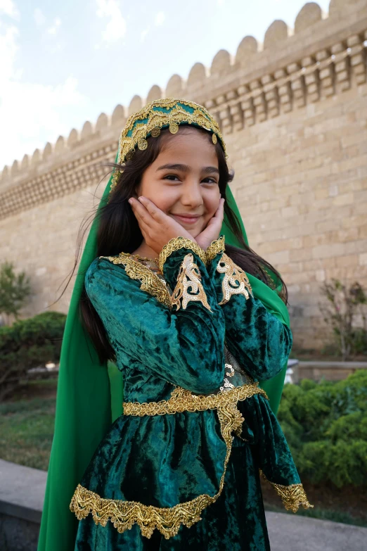 a little girl in costume and headpiece smiling