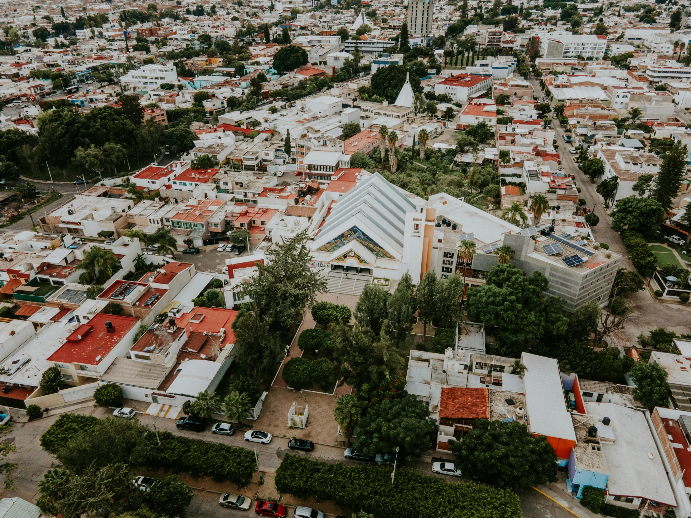 an aerial po of a city with a large building next to it