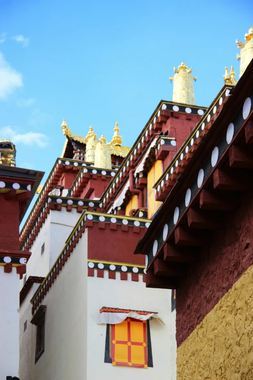 a building with gold roof tops and sky in the background