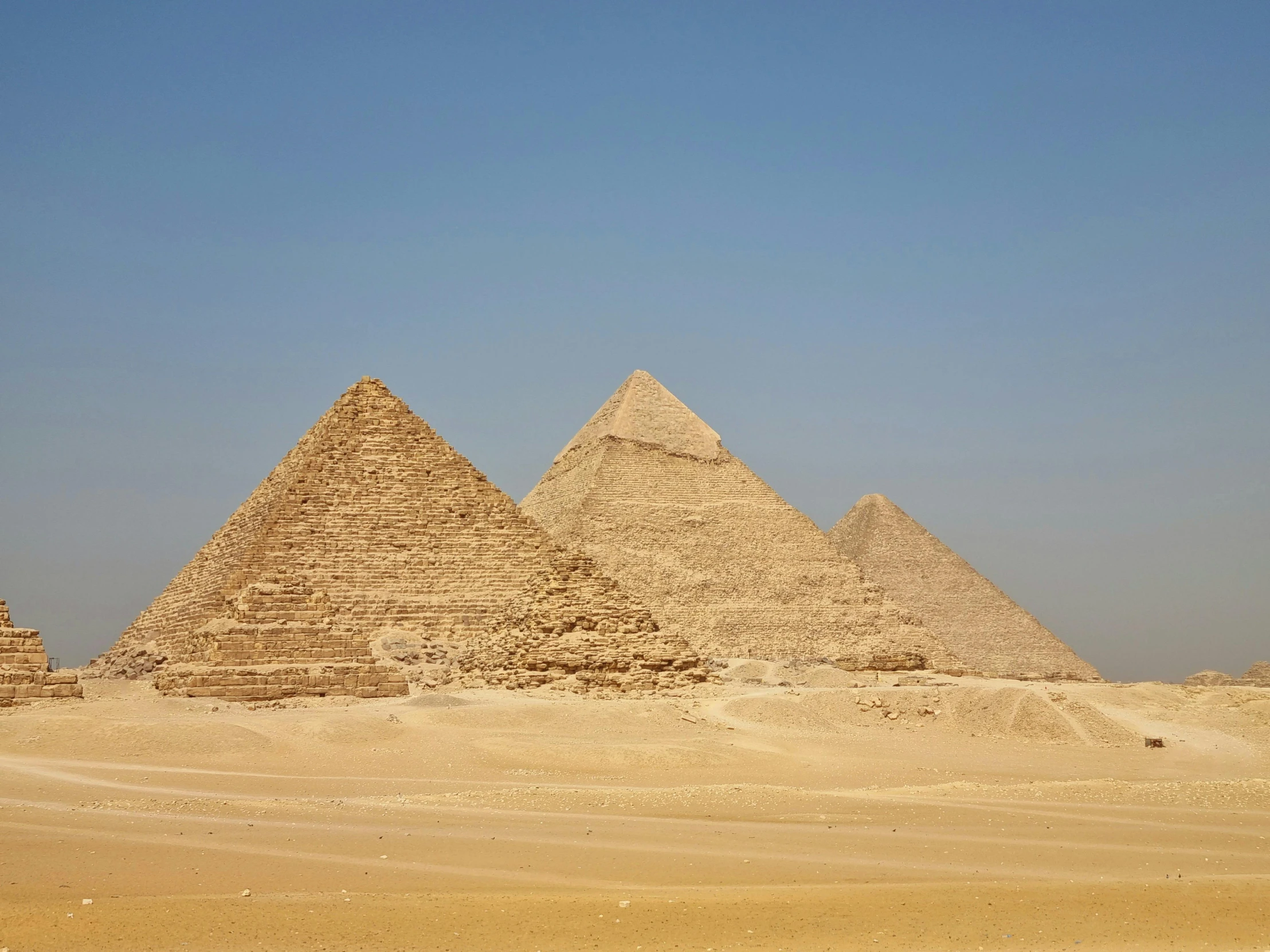 a large group of pyramids sitting in the desert