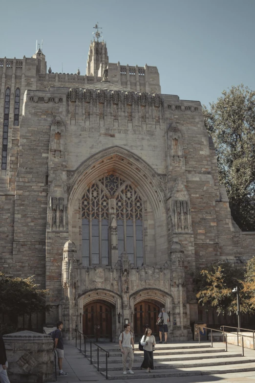 the exterior of the large castle like building with multiple people