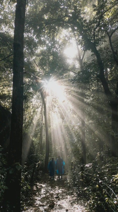 three people stand in the shade of the sun behind their backs