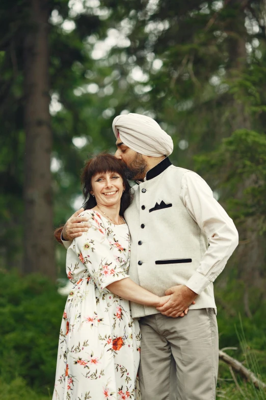 a pregnant man emcing his pregnant wife in the woods