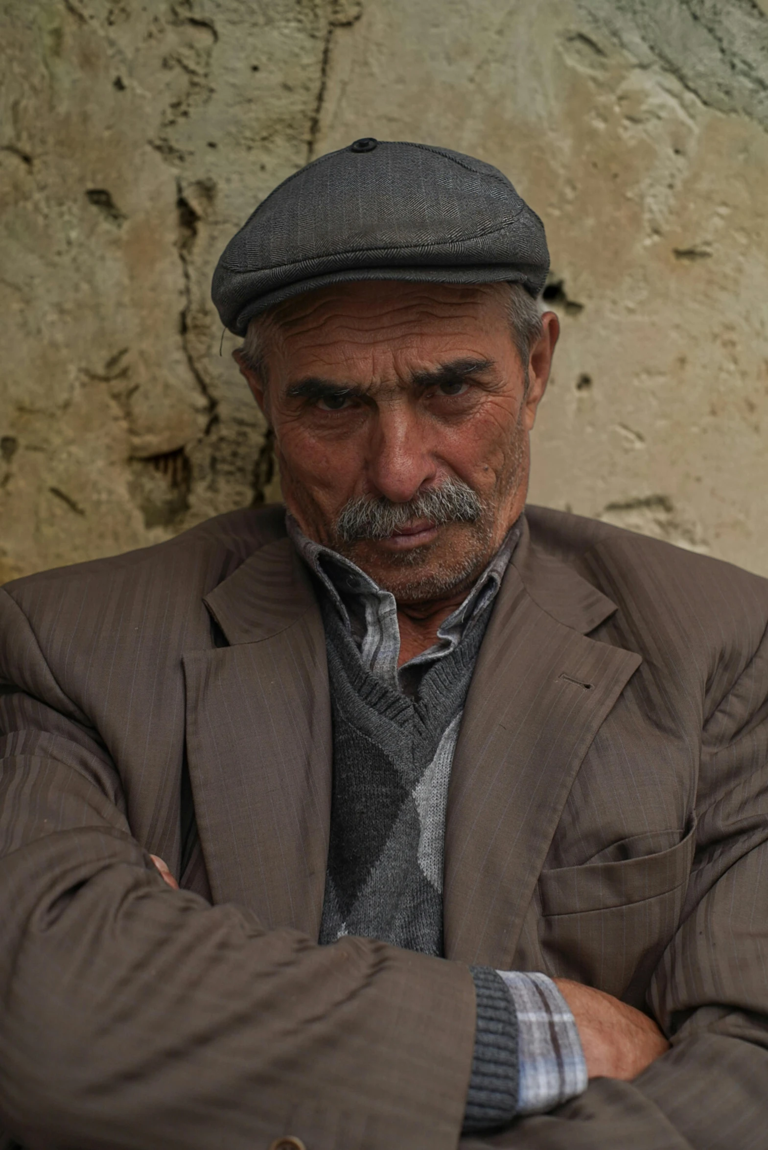 a man in a gray jacket and tie