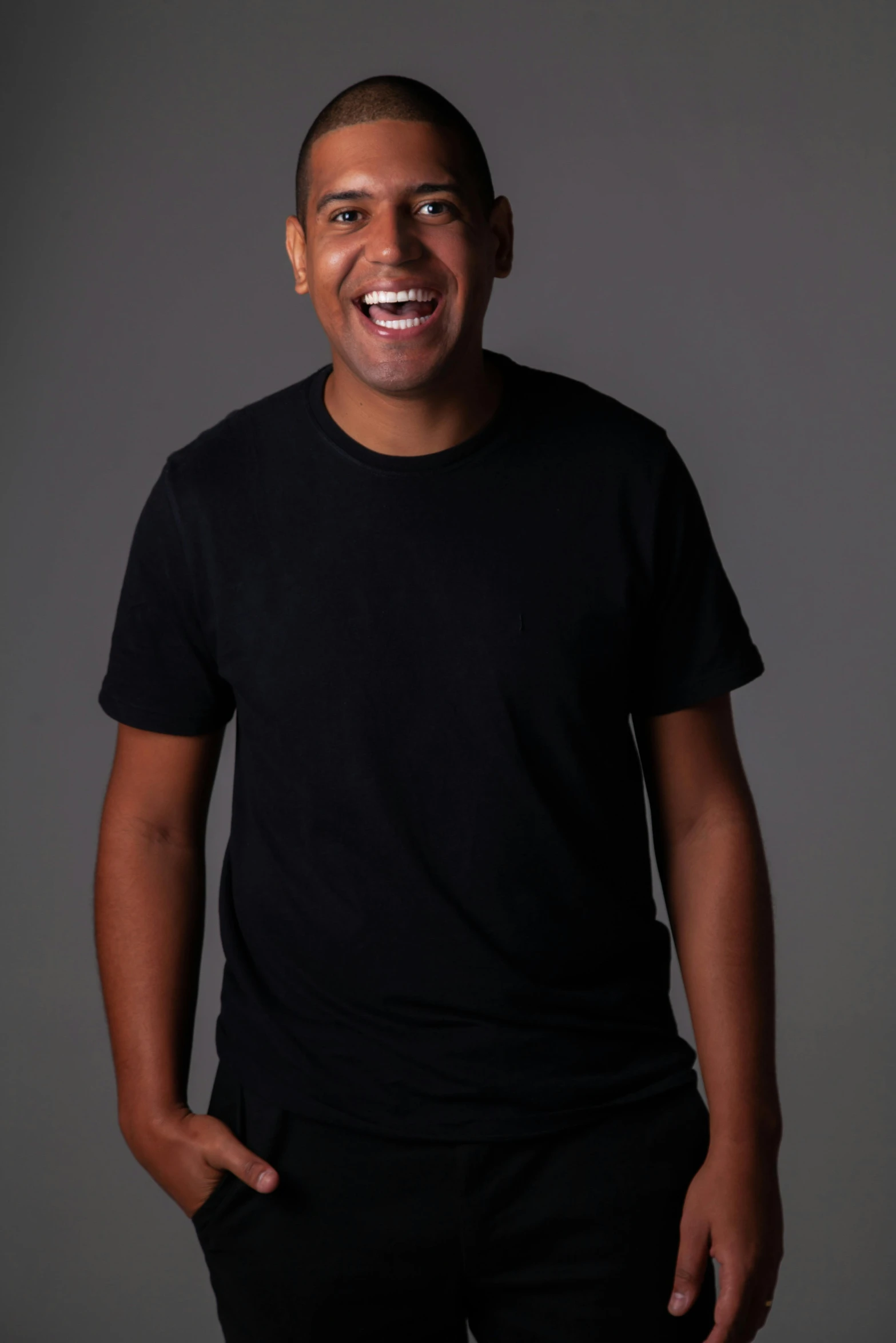 a man is smiling and wearing a black shirt