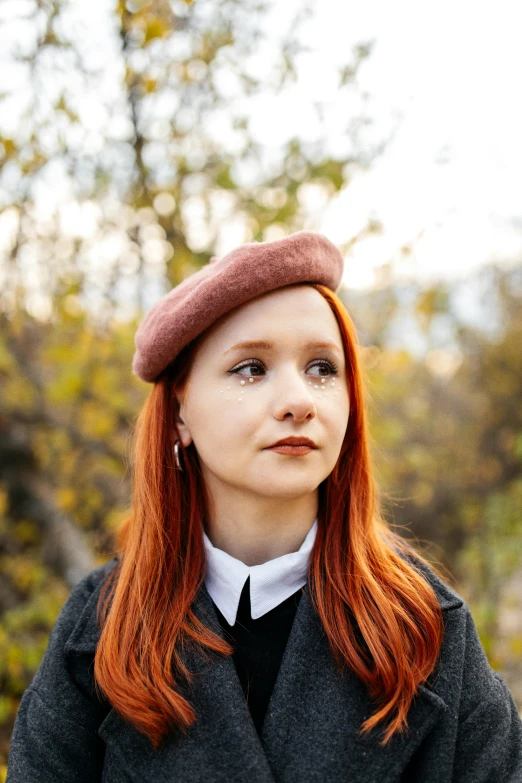 a woman with red hair wearing a school uniform looking at the camera