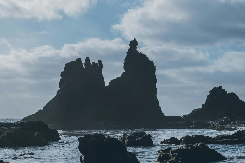 the rocky coastline has several small rocks near it