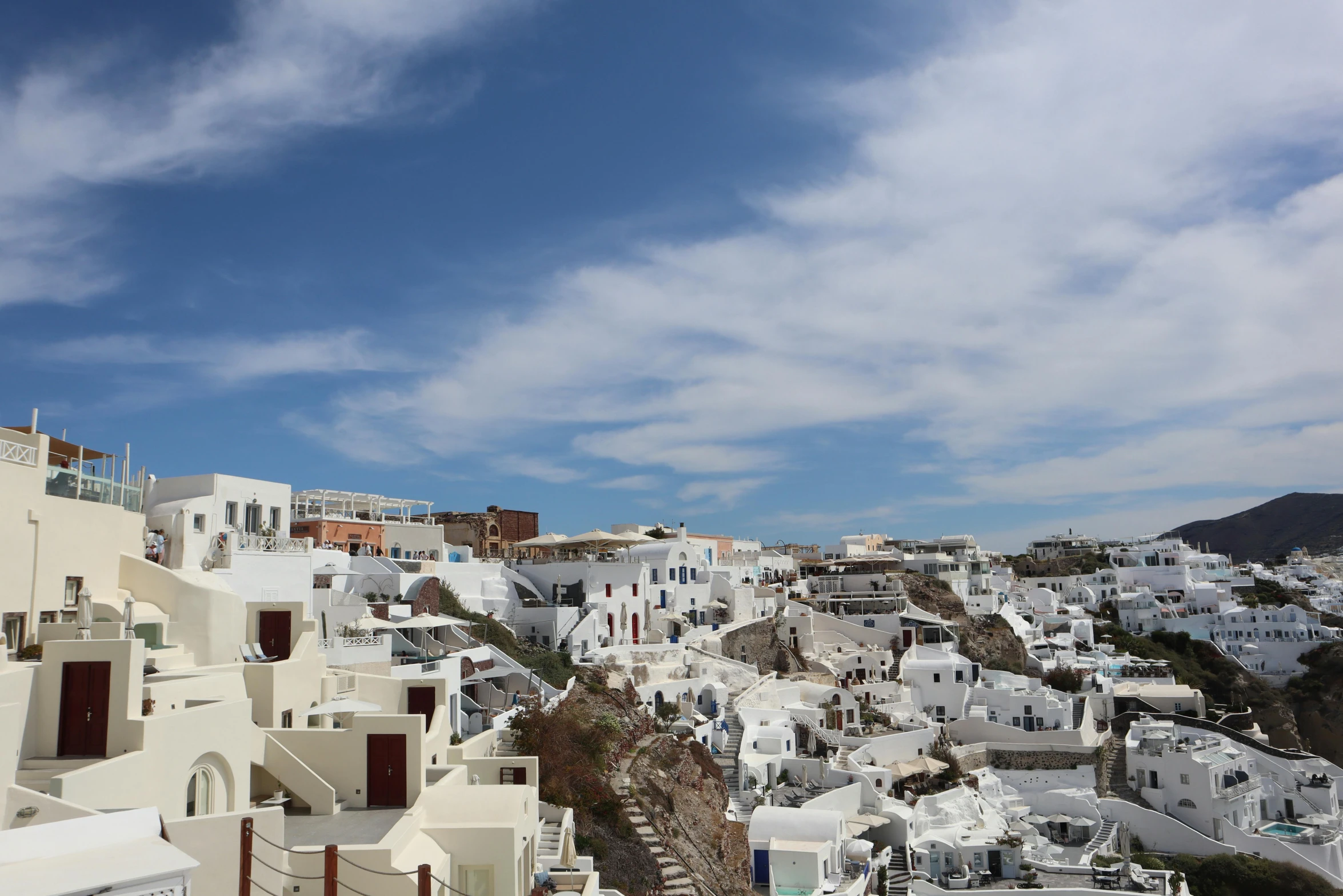 white colored buildings are against the blue sky