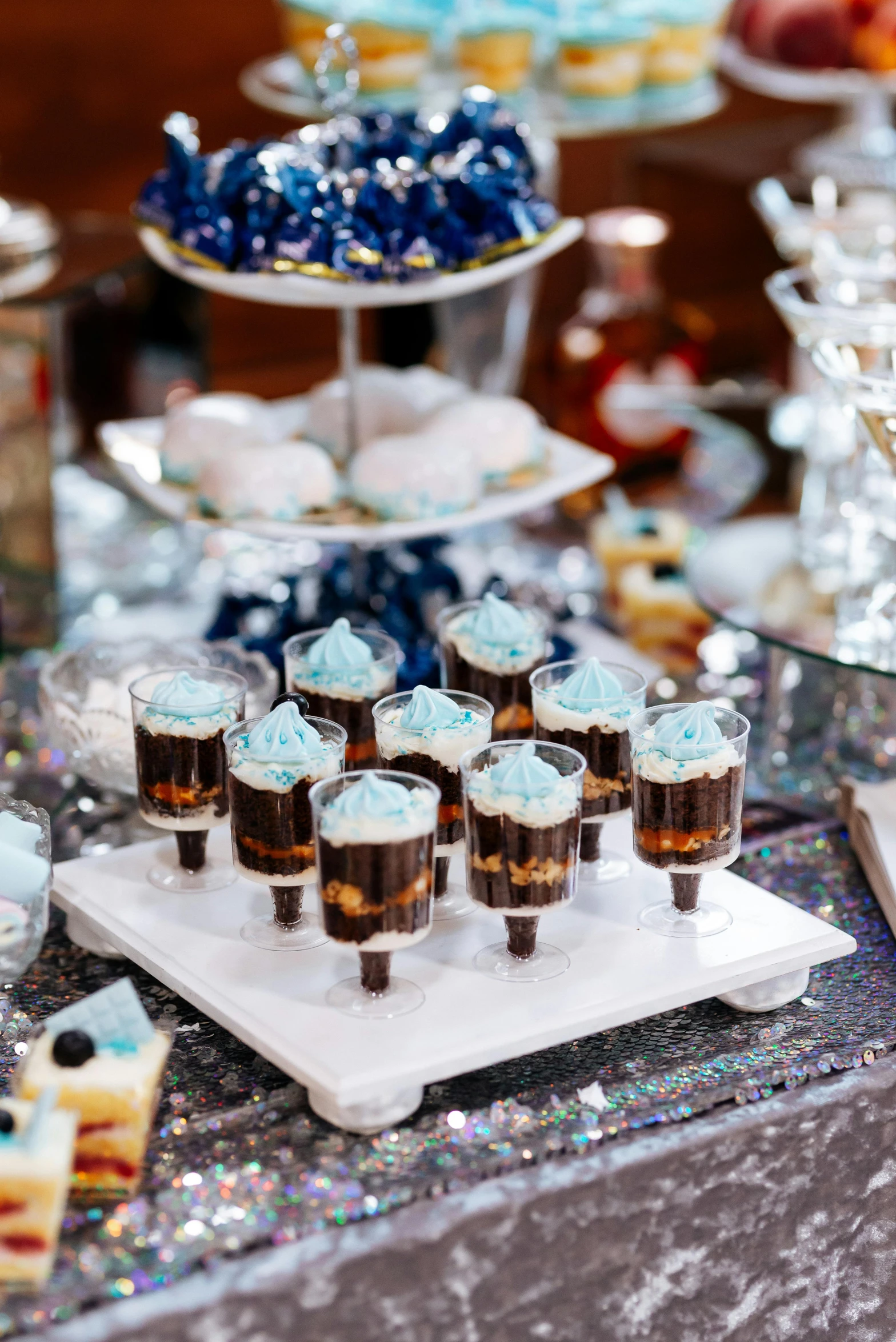 a tray with cups on it and some desserts sitting on a table