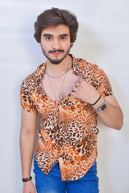 man standing wearing orange and black leopard print shirt