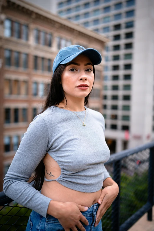 woman standing on city balcony with hand on hip