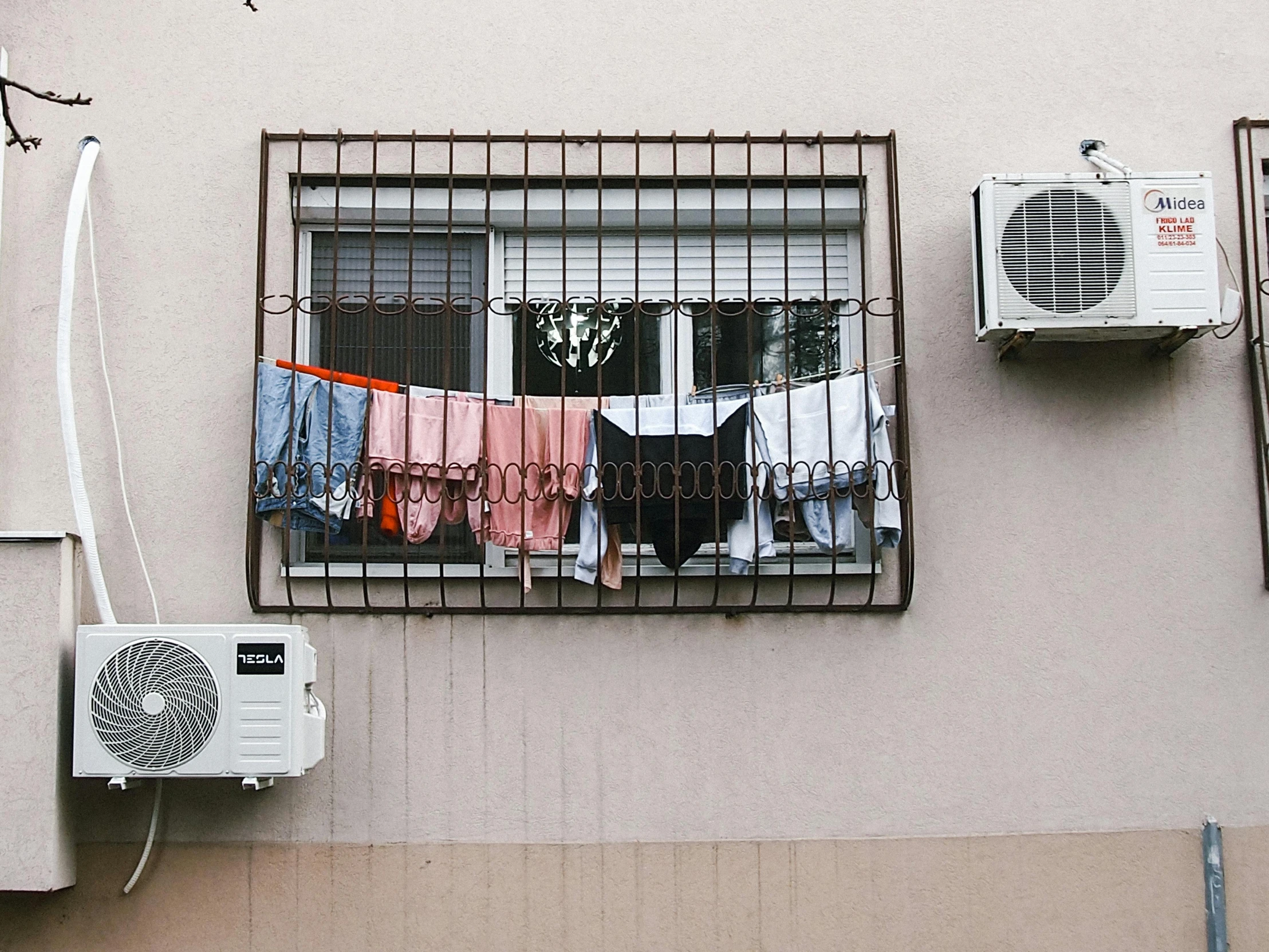 clothes hanging out to dry on a wire on a window