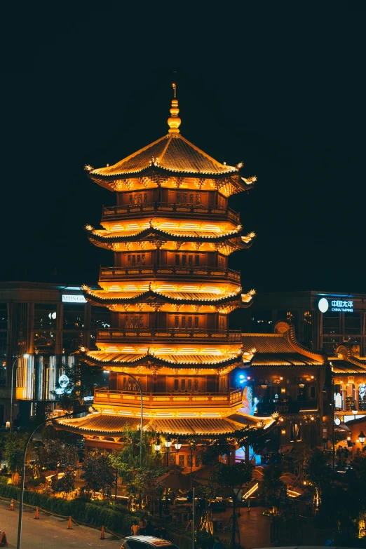 there is an asian tower lit up at night