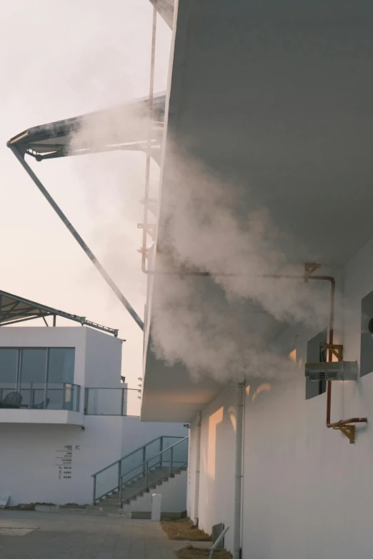 steam rises from the exhaust pipe in an industrial building