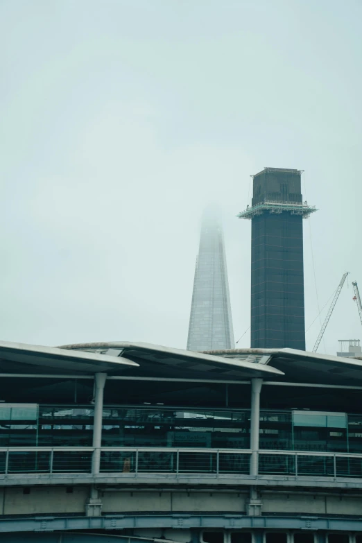 a building and a tower in the distance