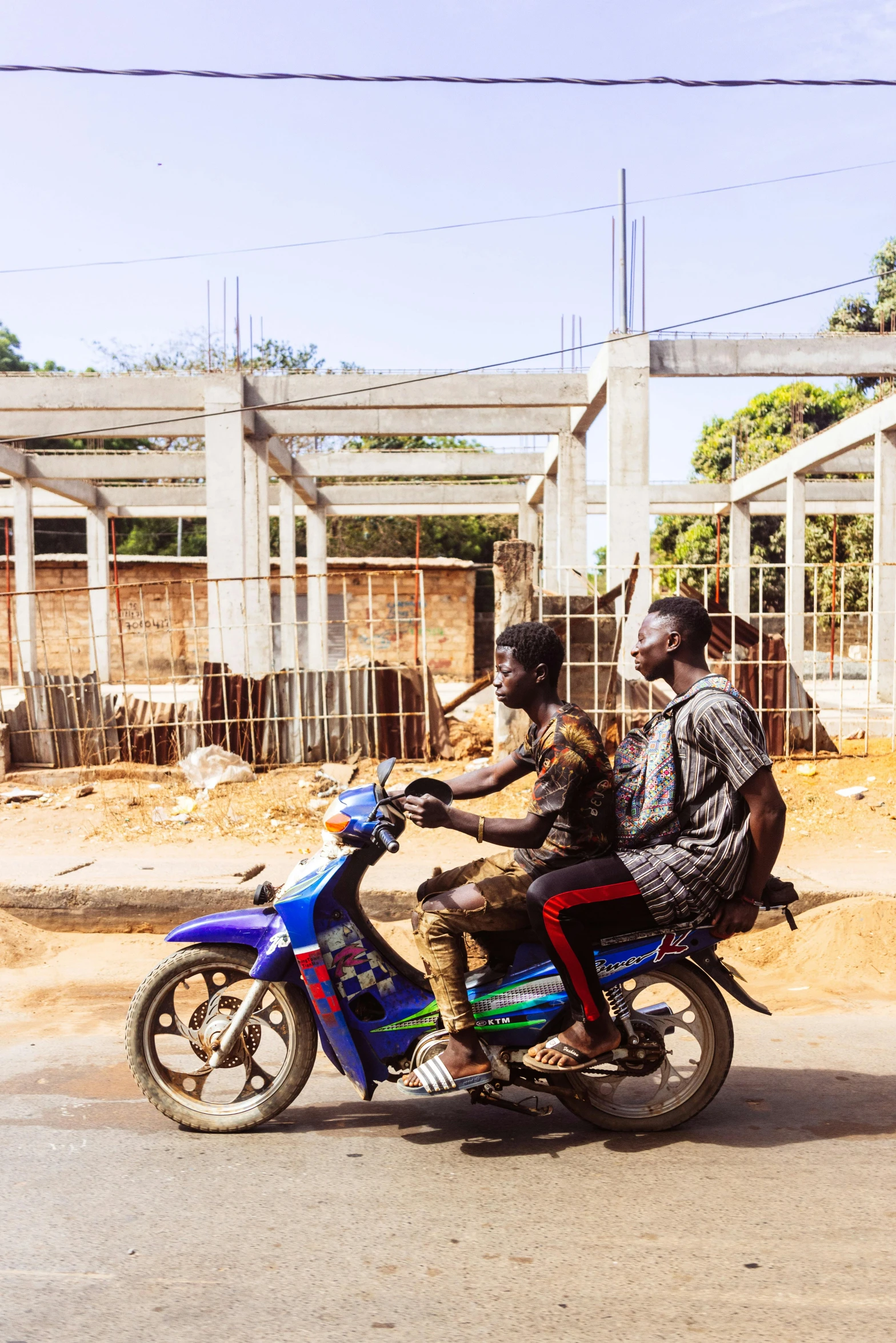 two men are riding on a motorcycle together