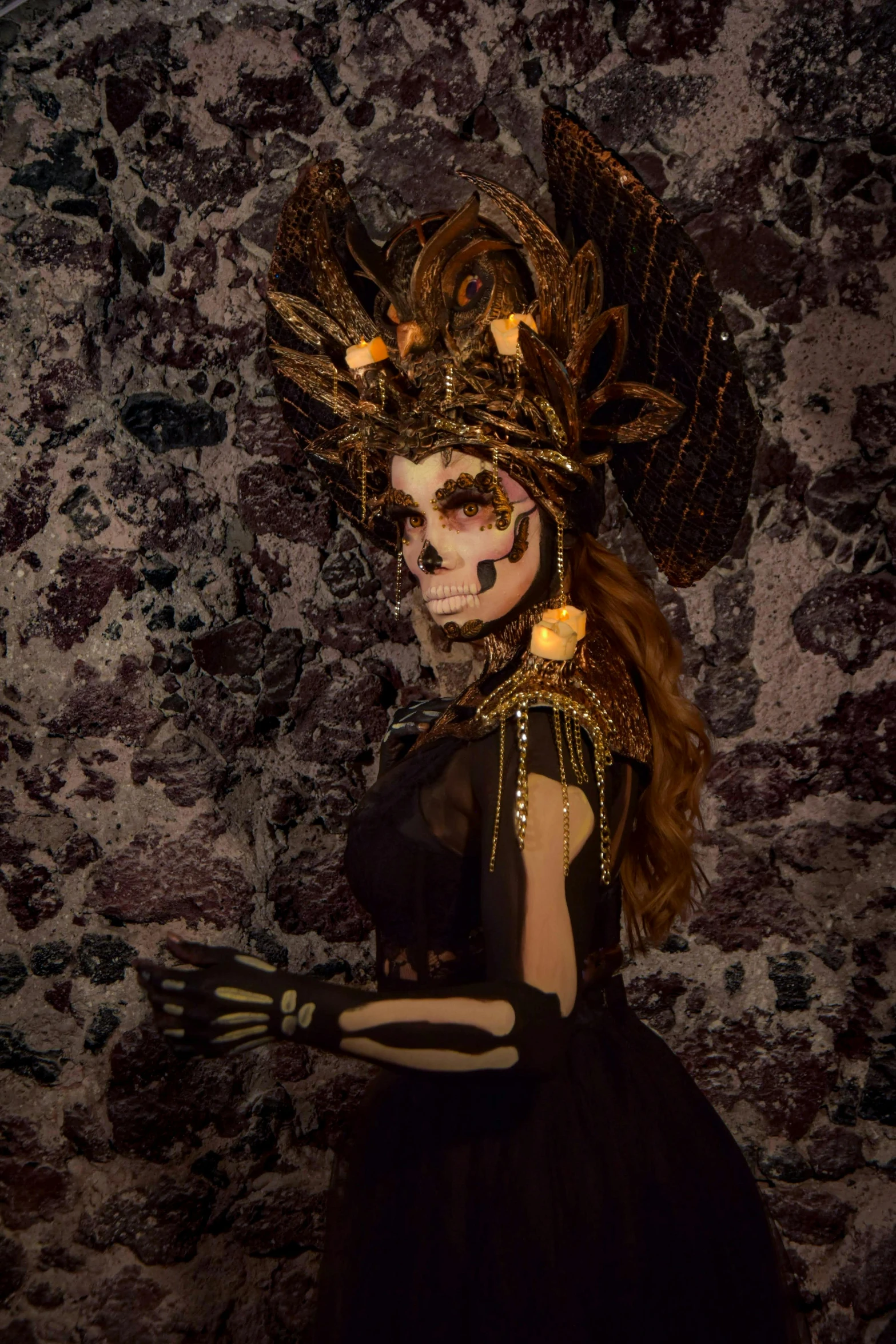 woman in costume wearing skeleton headpiece and lighting makeup