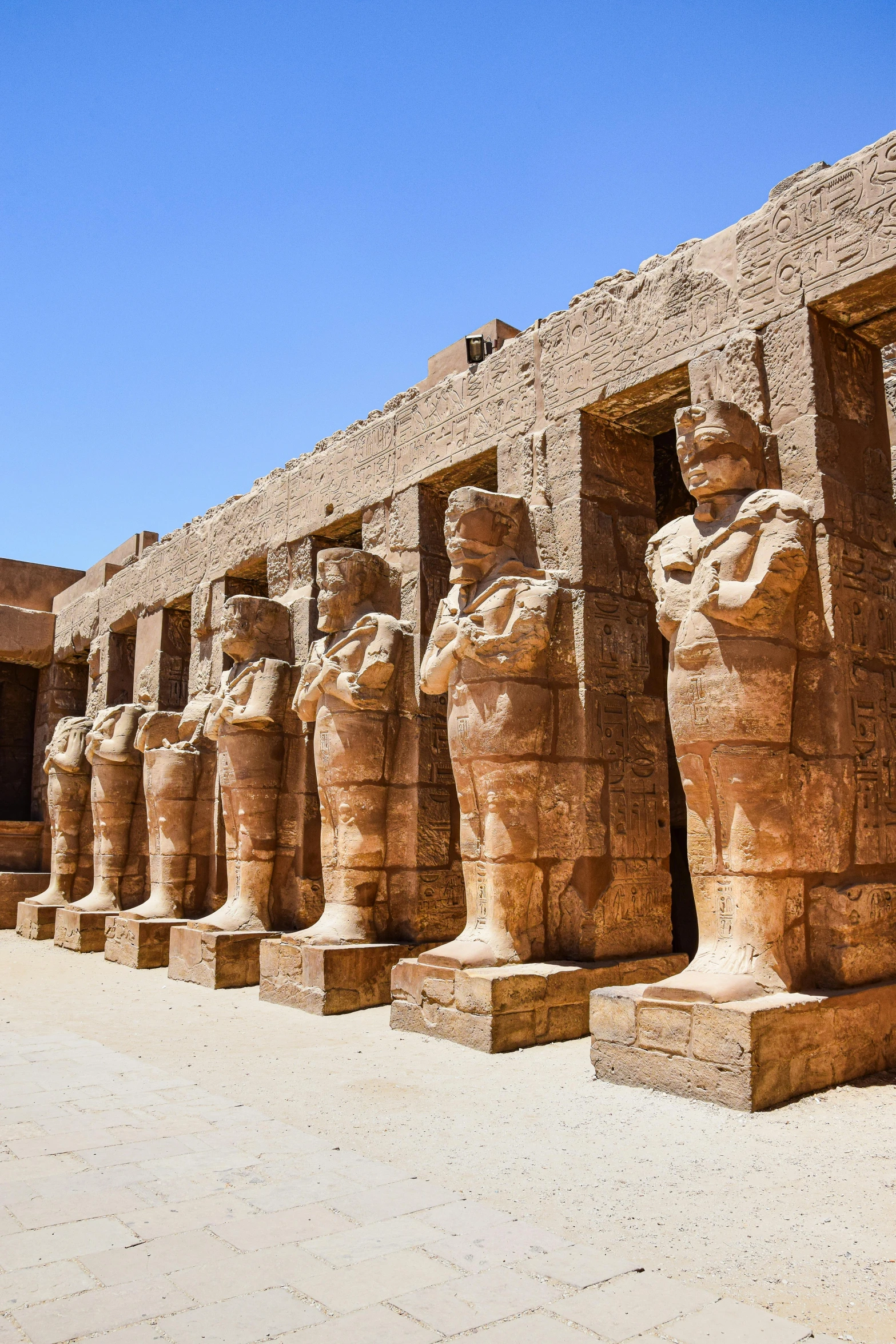 a line of huge ancient statues and some dirt