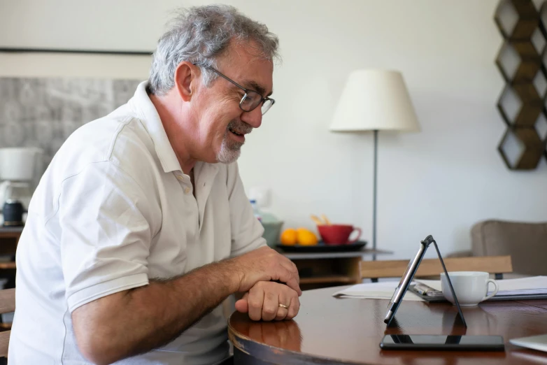 the older man is enjoying his time while at his desk