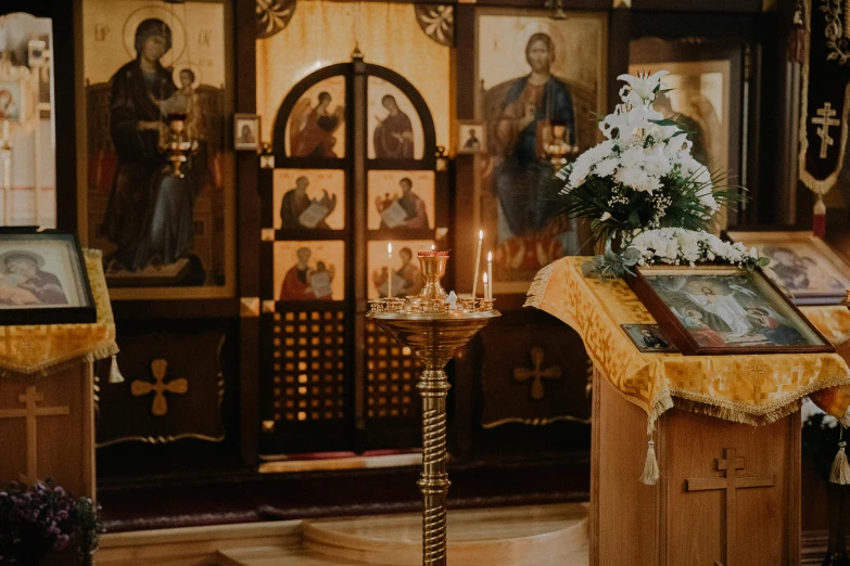 altar with candles and a picture and paintings of people