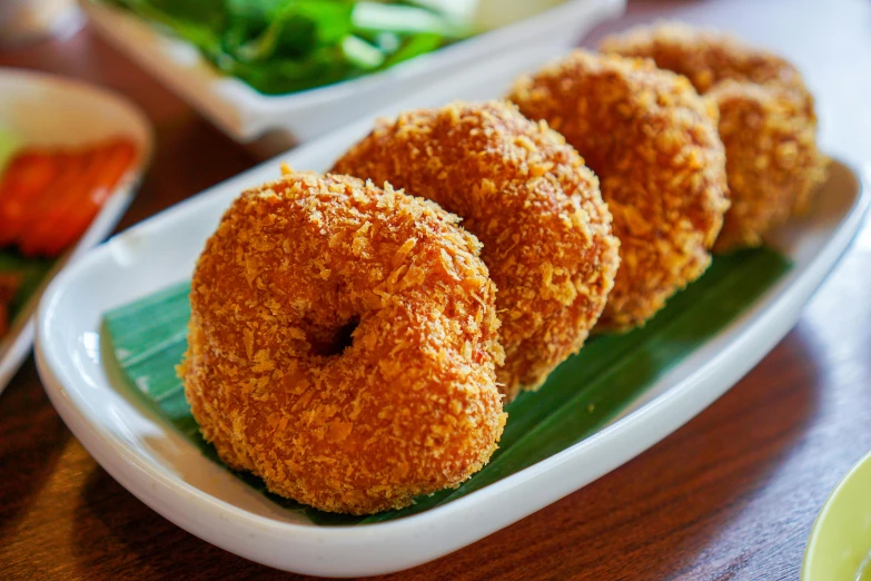 several sugar covered donuts sitting on a plate