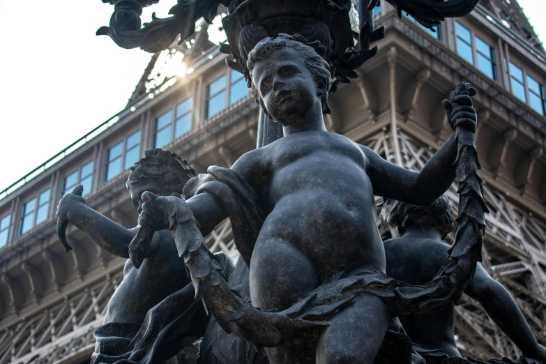 a large statue in front of the eiffel tower