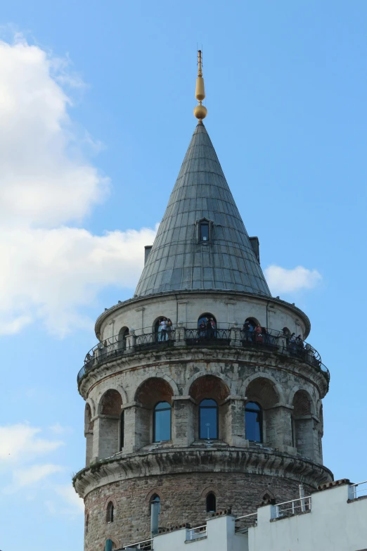 the top of the building has a gold spire