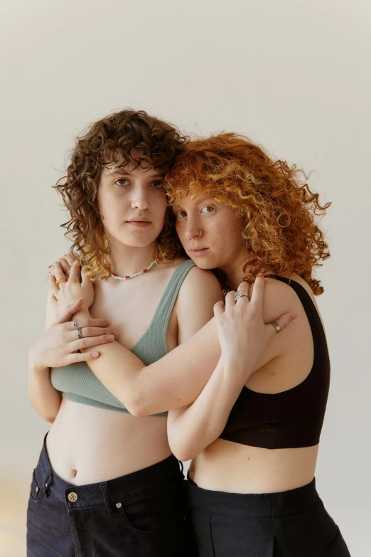 two beautiful young women hugging each other