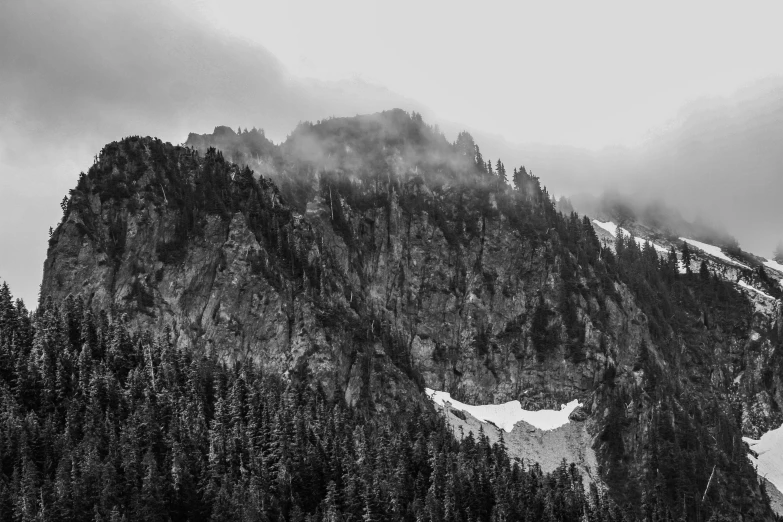 a very tall mountain covered in a low cloud